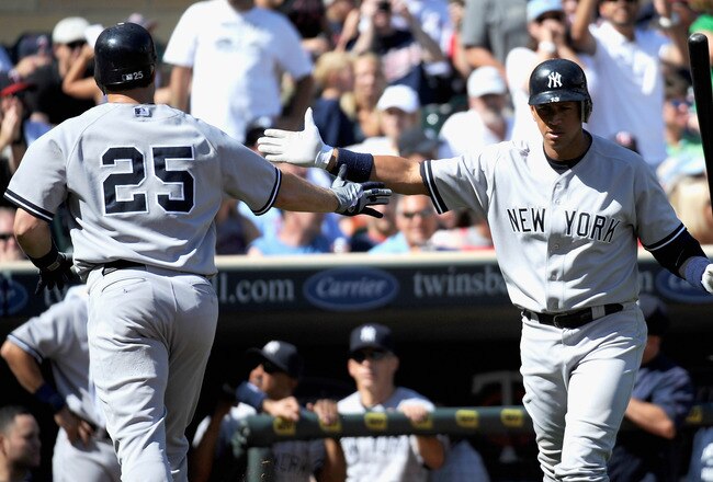 MINNEAPOLIS, MN - AUGUST 21: Alex Rodriguez #13 of the New York Yankees congratulates Mark Teixeira #25 of the New York Yankees on a solo home run against the Minnesota Twins in the seventh inning on August 21, 2011 at Target Field in Minneapolis, Minnesota. (Photo by Hannah Foslien/Getty Images)