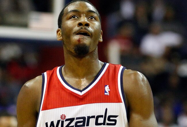 WASHINGTON, DC - FEBRUARY 08: John Wall #2 of the Washington Wizards walks on the court after colliding with Jeremy Lin #17 of the New York Knicks (not pictured) during the first half at Verizon Center on February 8, 2012 in Washington, DC.  NOTE TO USER: User expressly acknowledges and agrees that, by downloading and or using this photograph, User is consenting to the terms and conditions of the Getty Images License Agreement.  (Photo by Rob Carr/Getty Images)