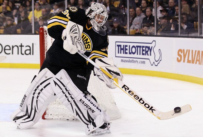 BOSTON, MA - JANUARY 31:  Tim Thomas #30 of the Boston Bruins clears the puck in the second period against the Ottawa Senators on January 31, 2012 at TD Garden in Boston, Massachusetts.  (Photo by Elsa/Getty Images)