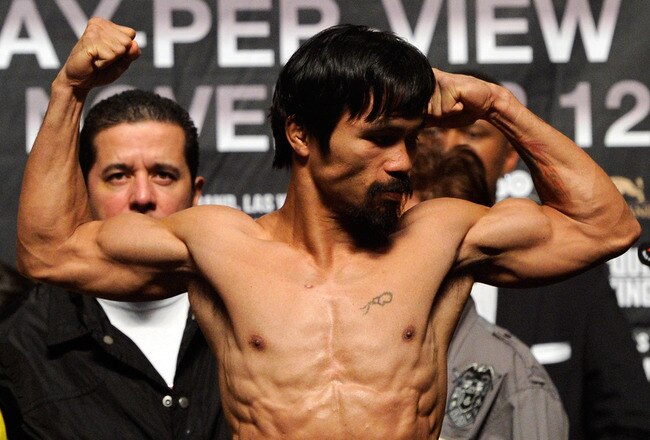 LAS VEGAS, NV - NOVEMBER 11:  Boxer Manny Pacquiao steps on the scale to weigh 143 pounds during the official weigh-in for his bout against Juan Manuel Marquez at the MGM Grand Garden Arena November 11, 2011 in Las Vegas, Nevada. Pacquiao will defend his WBO welterweight title against Marquez when the two meet in the ring for the third time on November 12 in Las Vegas.  (Photo by Ethan Miller/Getty Images)