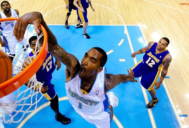 DENVER - MAY 25:  J.R. Smith #1 of the Denver Nuggets dunks the ball over Andrew Bynum #17 of the Los Angeles Lakers in Game Four of the Western Conference Finals during the 2009 NBA Playoffs at Pepsi Center on May 25, 2009 in Denver, Colorado. NOTE TO USER: User expressly acknowledges and agrees that, by downloading and or using this photograph, User is consenting to the terms and conditions of the Getty Images License Agreement.  (Photo by Larry W. Smith-Pool/Getty Images)