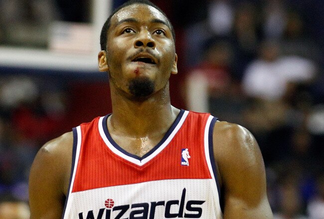 WASHINGTON, DC - FEBRUARY 08: John Wall #2 of the Washington Wizards walks on the court after colliding with Jeremy Lin #17 of the New York Knicks (not pictured) during the first half at Verizon Center on February 8, 2012 in Washington, DC.  NOTE TO USER: User expressly acknowledges and agrees that, by downloading and or using this photograph, User is consenting to the terms and conditions of the Getty Images License Agreement.  (Photo by Rob Carr/Getty Images)