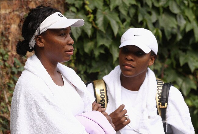 WIMBLEDON, ENGLAND - JUNE 18:  Venus Williams (L) and Serena Williams conclude their training session on the Aorangi Practice court at the All England Lawn Tennis and Croquet Club ahead of the Wimbledon Lawn Tennis Championships on June 18, 2011 in London, England. The Championships, which are celebrating their 125th anniversary this year, begin on June 20.   (Photo by Oli Scarff/Getty Images)