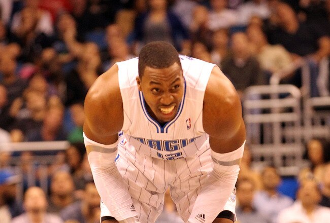 ORLANDO, FL - FEBRUARY 06:  Dwight Howard #12 of the Orlando Magic grimmaces during the game against the Los Angeles Clippers at Amway Center on February 6, 2012 in Orlando, Florida.   NOTE TO USER: User expressly acknowledges and agrees that, by downloading and or using this Photograph, user is consenting to the terms and conditions of the Getty Images License Agreement.  (Photo by Sam Greenwood/Getty Images)