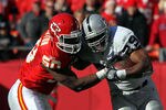 KANSAS CITY, MO - DECEMBER 24:  Justin Houston #50 of the Kansas City Chiefs tackles Michael Bush #29 of the Oakland Raiders as Bush carries the ball upfield during the game on December 24, 2011 at Arrowhead Stadium in Kansas City, Missouri.  (Photo by Jamie Squire/Getty Images)