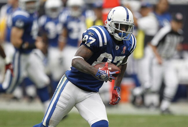 HOUSTON - SEPTEMBER 11:  Wide receiver Reggie Wayne #87 of the Indianapolis Colts looks for room to run after a reception against the Houston Texans during the season-opening game at Reliant Stadium on September 11, 2011 in Houston, Texas.  (Photo by Bob Levey/Getty Images)