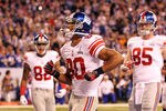 INDIANAPOLIS, IN - FEBRUARY 05:  Victor Cruz #80 of the New York Giants celebrates in the end zone after catching a two yard touchdown pass from Eli Manning #10 in the first quarter against the New England Patriots during Super Bowl XLVI at Lucas Oil Stadium on February 5, 2012 in Indianapolis, Indiana.  (Photo by Jamie Squire/Getty Images)