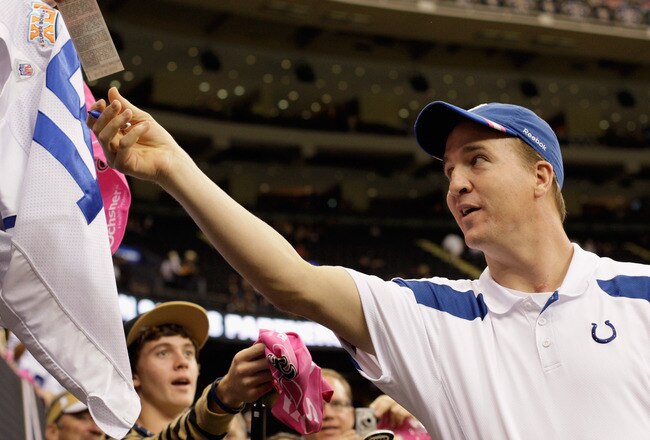 NEW ORLEANS, LA - OCTOBER 23:  Peyton Manning #18 of the Indianapolis Colts signs autographs for fans before the Colts take on the New Orleans Saints  at Mercedes-Benz Superdome on October 23, 2011 in New Orleans, Louisiana.  Manning is sidelined for the season with a neck injury.  (Photo by Jamie Squire/Getty Images)