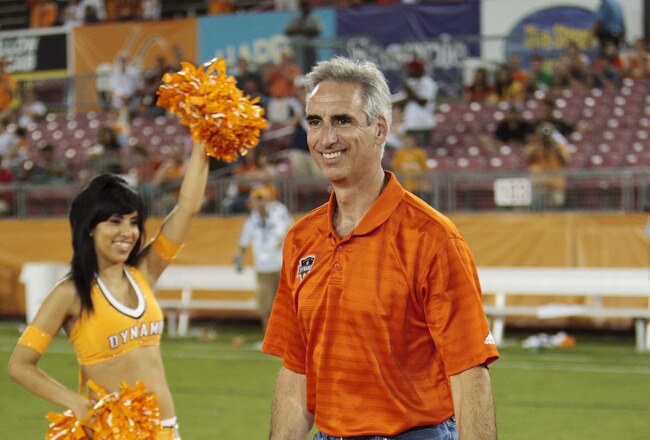 HOUSTON - JUNE 26:  Houston Dynamo President and General Manager Oliver Luck receives some gifts from the Dynamo's Chris Canetti after the game at Robertson Stadium on June 26, 2010 in Houston, Texas. Luck is leaving the Dynamo to take the athletic directors position at West Virginia.  (Photo by Bob Levey/Getty Images)