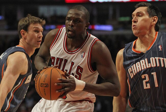 CHICAGO, IL - JANUARY 21:  Loul Deng #9 of the Chicago Bulls moves between Matt Carroll #33 and Eduardo Najera #21 of the Charlotte Bobcats at the United Center on January 21, 2012 in Chicago, Illinois. The Bulls defeated the Bobcats 95-89. NOTE TO USER: User expressly acknowledges and agrees that, by downloading and or using this photograph, User is consenting to the terms and conditions of the Getty Images License Agreement.  (Photo by Jonathan Daniel/Getty Images)