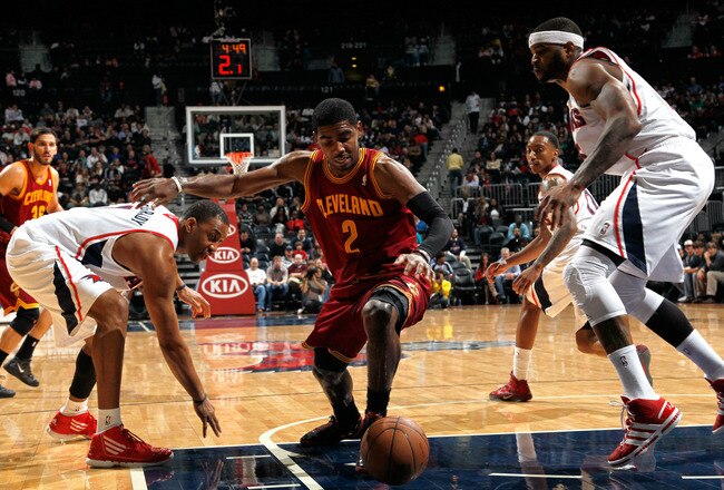 ATLANTA, GA - JANUARY 21:  Josh Smith #5 of the Atlanta Hawks defends as Tracy McGrady #1 strips the ball from Kyrie Irving #2 of the Cleveland Cavaliers at Philips Arena on January 21, 2012 in Atlanta, Georgia.  NOTE TO USER: User expressly acknowledges and agrees that, by downloading and or using this photograph, User is consenting to the terms and conditions of the Getty Images License Agreement.  (Photo by Kevin C. Cox/Getty Images)