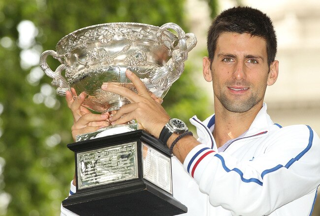 MELBOURNE, AUSTRALIA - JANUARY 30:  Novak Djokovic of Serbia poses with the Norman Brookes Challenge Cup after winning the 2012 men's Australian Open, at Carlton Gardens on January 30, 2012 in Melbourne, Australia.  (Photo by Lucas Dawson/Getty Images)