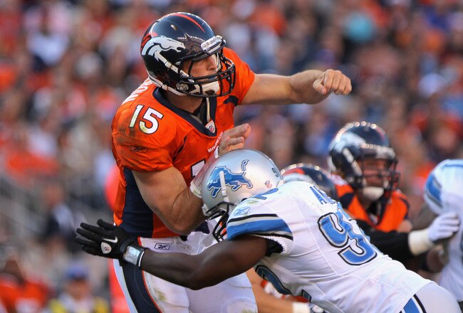 DENVER, CO - OCTOBER 30:  Quarterback Tim Tebow #15 of the Denver Broncos is hit by Cliff Avril #92 of the Detroit Lions as he delivers a pass Sports Authority at Invesco Field at Mile High on October 30, 2011 in Denver, Colorado. The Lions defeated the Broncos 45-10.  (Photo by Doug Pensinger/Getty Images)