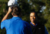 PEBBLE BEACH, CA - FEBRUARY 09:  American football player Tony Romo (L) and playing partner Tiger Woods shake hands following their round during the AT&T Pebble Beach National Pro-Am at the Spyglass Hill Golf on February 9, 2012 in Pebble Beach, California.  (Photo by Jeff Gross/Getty Images)