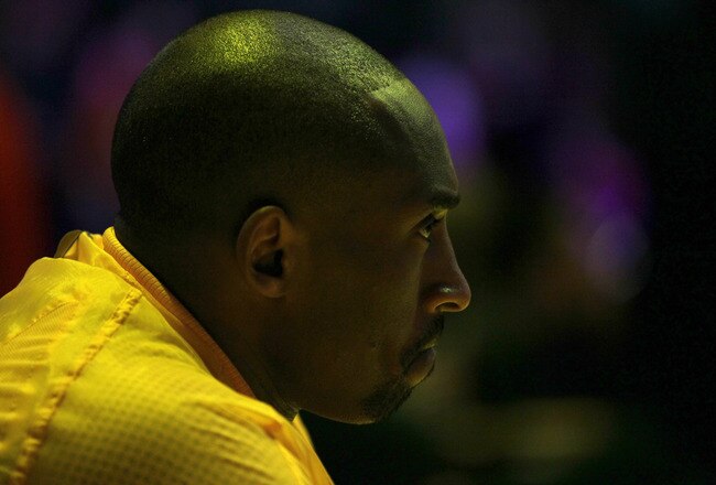 LOS ANGELES, CA - JANUARY 10:  Kobe Bryant #24 of the Los Angeles Lakerssits on the bench during pregame introductions before the game with the Phoenix Suns at Staples Center on January 10, 2012 in Los Angeles, California. NOTE TO USER: User expressly acknowledges and agrees that, by downloading and or using this photograph, User is consenting to the terms and conditions of the Getty Images License Agreement.  (Photo by Stephen Dunn/Getty Images)