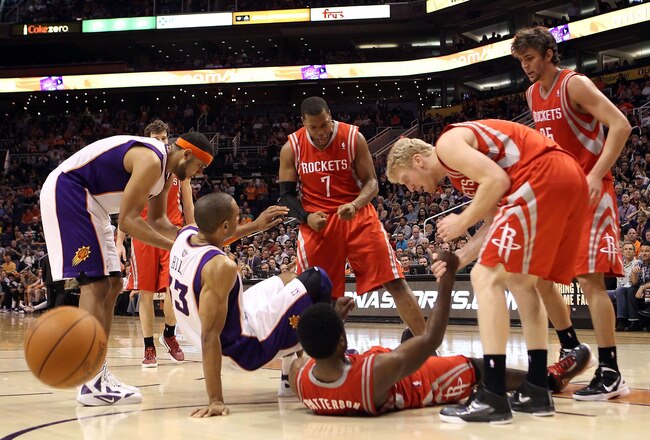 PHOENIX, AZ - FEBRUARY 09:  Kyle Lowry #7 of the Houston Rockets celebrates after a foul was called on Grant Hill #33 of the Phoenix Suns during the NBA game at US Airways Center on February 9, 2012 in Phoenix, Arizona. The Rockets defeated the Suns 96-89.  NOTE TO USER: User expressly acknowledges and agrees that, by downloading and or using this photograph, User is consenting to the terms and conditions of the Getty Images License Agreement.  (Photo by Christian Petersen/Getty Images)