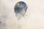 MORGANTOWN, WV - NOVEMBER 25: A member of the West Virginia Mountaineers holds up his helmet before the take the field against the University of Pittsburgh Panthers during the 2011 Backyard Brawl on November 25, 2011 at Mountaineer Field in Morgantown, West Virginia.  (Photo by Jared Wickerham/Getty Images)