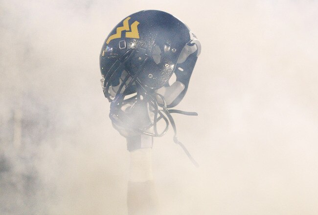 MORGANTOWN, WV - NOVEMBER 25: A member of the West Virginia Mountaineers holds up his helmet before the take the field against the University of Pittsburgh Panthers during the 2011 Backyard Brawl on November 25, 2011 at Mountaineer Field in Morgantown, West Virginia.  (Photo by Jared Wickerham/Getty Images)
