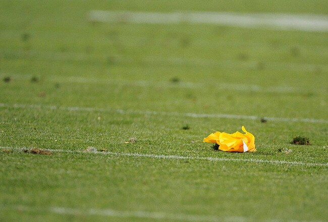 DENVER, CO - SEPTEMBER 12:  A penalty flag lies on the turf during the game between the Oakland Raiders and the Denver Broncos at Sports Authority Field at Mile High on September 12, 2011 in Denver, Colorado.  (Photo by Garrett W. Ellwood/Getty Images)