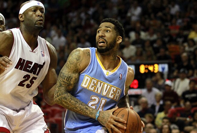 MIAMI, FL - MARCH 19:  Forward Wilson Chandler #21 of the Denver Nuggets drives against Center Erick Dampier #25 of the Miami Heat at American Airlines Arena on March 19, 2011 in Miami, Florida.  The Heat defeated the Nuggets 103-98. NOTE TO USER: User expressly acknowledges and agrees that, by downloading and/or using this Photograph, User is consenting to the terms and conditions of the Getty Images License Agreement.  (Photo by Marc Serota/Getty Images)