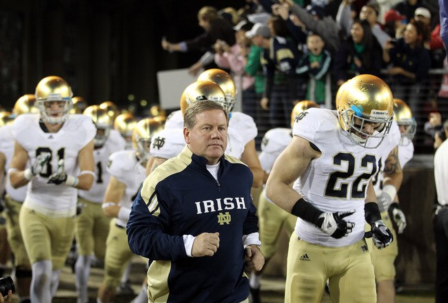 STANFORD, CA - NOVEMBER 26:  Notre Dame Fighting Irish head coach Brian Kelly run on to the field for their game against the Stanford Cardinal at Stanford Stadium on November 26, 2011 in Stanford, California.  (Photo by Ezra Shaw/Getty Images)