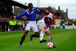 ARBROATH, SCOTLAND - JANUARY 08:  Rangers player Sone Aluko (l) challenges Josh Falkingham of Abroath during the William Hill Scottish Cup Fourth Round match between Arbroath and Rangers at Gayfield park on January 8, 2012 in Arbroath, Scotland.  (Photo by Stu Forster/Getty Images)