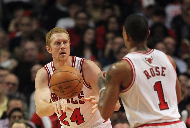CHICAGO, IL - JANUARY 23:  Brian Scalabrine #24 of the Chicago Bulls passes to Derrick Rose #1 against the New Jersey Nets at the United Center on January 23, 2012 in Chicago, Illinois. The Bulls defeated the Nets 110-95. NOTE TO USER: User expressly acknowledges and agrees that, by downloading and or using this photograph, User is consenting to the terms and conditions of the Getty Images License Agreement.  (Photo by Jonathan Daniel/Getty Images)