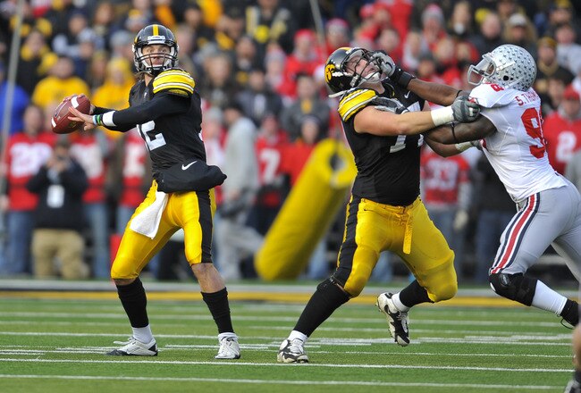 IOWA CITY, IA - NOVEMBER 20:  Quarterback Ricky Stanzi #12 of the University of Iowa Hawkeyes throws under pressure from defensive lineman Solomon Thomas #98 of the Ohio State Buckeyes as offensive lineman Riley Reiff #77 defends during the first half of play at Kinnick Stadium on November 20, 2010 in Iowa City, Iowa. Ohio State won 20-17 over Iowa. (Photo by David Purdy/Getty Images)