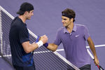 SHANGHAI, CHINA - OCTOBER 13:  Roger Federer of Switzerland shakes hand with John Isner of USA after their match during day three of the 2010 Shanghai Rolex Masters at the Shanghai Qi Zhong Tennis Center on October 13, 2010 in Shanghai, China.  (Photo by Victor Fraile/Getty Images)