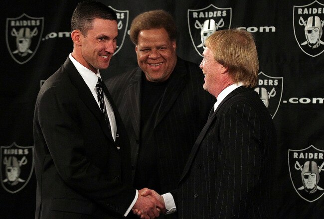 ALAMEDA, CA - JANUARY 30:  New Oakland Raiders head coach Dennis  Allen (L) greets Raiders general manager Reggie McKenzie (C) and team owner Mark Davis during a press conference on January 30, 2012 in Alameda, California. Dennis Allen was introduced as the new coach of the Oakland Raiders, replacing Hue Jackson who was fired after one season.  (Photo by Justin Sullivan/Getty Images)
