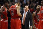 BOSTON, MA - JANUARY 13:  Head coach Tom Thibodeau talks with his players during a time out in the fourth quarter against the Boston Celtics on January 13, 2012 at TD Garden in Boston, Massachusetts. The Chicago Bulls defeated the Boston Celtics 88-79. NOTE TO USER: User expressly acknowledges and agrees that, by downloading and or using this photograph, User is consenting to the terms and conditions of the Getty Images License Agreement.  (Photo by Elsa/Getty Images)