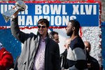 NEW YORK, NY - FEBRUARY 07:  Quarterback Eli Manning #10 (L) of the New York Giants and Super Bowl XLVI MVP holds the Vince Lombardi Trophy as Justin Tuck #91 (R) of the New York Giants looks on during the Giants' Victory Parade on February 7, 2012 in New York City. The Giants defeated the New England Patriots 21-17 in Super Bowl XLVI.  (Photo by Andrew Burton/Getty Images)