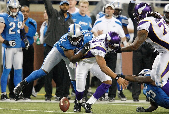 DETROIT, MI - DECEMBER 11: Joe Webb #14 of the Minnesota Vikings fumbles the ball late in the fourth quarter and the ball is recovered by Cliff Avril #92 of the Detroit Lions during the game at Ford Field on December 11, 2011 in Detroit, Michigan. The Lions defeated the Vikings  34-28. (Photo by Leon Halip/Getty Images)