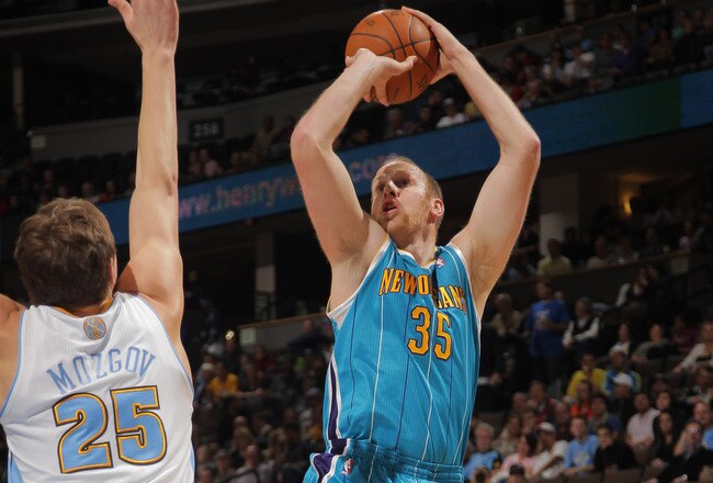 DENVER, CO - JANUARY 09:  Chris Kaman #35 of the New Orleans Hornets takes a shot over Timofey Mozgov #25 of the Denver Nuggets at the Pepsi Center on January 9, 2012 in Denver, Colorado. The Hornets defeated the Nuggets 94-81. NOTE TO USER: User expressly acknowledges and agrees that, by downloading and or using this photograph, User is consenting to the terms and conditions of the Getty Images License Agreement.  (Photo by Doug Pensinger/Getty Images)