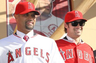 ANAHEIM, CA - DECEMBER 10:  Albert Pujols #5 (L) and C.J. Wilson #33 stand together at a public press conference introducing them as newly signed Los Angeles Angels of Anaheim  players at Angel Stadium on December 10, 2011 in Anaheim, California.  (Photo by Stephen Dunn/Getty Images)