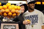 MIAMI GARDENS, FL - JANUARY 04:  (L-R) Head coach Dana Holgorsen and Geno Smith #12 of the West Virginia Mountaineers celebrate with the trophy after they won 70-33 against the Clemson Tigers during the Discover Orange Bowl at Sun Life Stadium on January 4, 2012 in Miami Gardens, Florida.  (Photo by Mike Ehrmann/Getty Images)