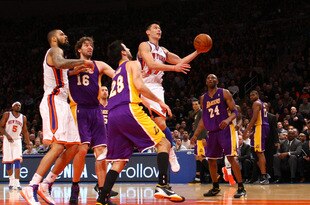 NEW YORK, NY - FEBRUARY 10:  Jeremy Lin #17 of the New York Knicks drives for a shot attempt in the fourth quarter against Jason Kapono #28 and Kobe Bryant #24 of the Los Angeles Lakers at Madison Square Garden on February 10, 2012 in New York City.  NOTE TO USER: User expressly acknowledges and agrees that, by downloading and or using this photograph, User is consenting to the terms and conditions of the Getty Images License Agreement.  (Photo by Chris Chambers/Getty Images)