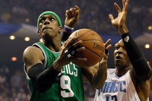 ORLANDO, FL - MAY 18:  Rajon Rondo #9 of the Boston Celtics drives for a shot attempt against Jameer Nelson #14 and Dwight Howard #12 of the Orlando Magic in Game Two of the Eastern Conference Finals during the 2010 NBA Playoffs at Amway Arena on May 18, 2010 in Orlando, Florida.  NOTE TO USER: User expressly acknowledges and agrees that, by downloading and/or using this Photograph, user is consenting to the terms and conditions of the Getty Images License Agreement.  (Photo by Kevin C. Cox/Getty Images)