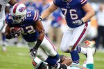 MIAMI GARDENS, FL - NOVEMBER 20:  Running back Fred Davis #22 of the Buffulo Bills is brought down by Safety Yeremiah Bell #37 of the Miami Dolphins at Sun Life Stadium on November 20, 2011 in Miami Gardens, Florida.  (Photo by Marc Serota/Getty Images)