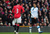 MANCHESTER, ENGLAND - FEBRUARY 11:  Luis Suarez of Liverpool looks at Patrice Evra of Manchester United during the Barclays Premier League match between Manchester United and Liverpool at Old Trafford on February 11, 2012 in Manchester, England.  (Photo by Shaun Botterill/Getty Images)