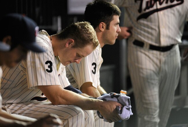 MINNEAPOLIS, MN - AUGUST 23: Justin Morneau #33 and Joe Mauer #7 of the Minnesota Twins sit in the dugout during the eighth inning against the Baltimore Orioles on August 23, 2011 at Target Field in Minneapolis, Minnesota. The Orioles defeated the Twins 8-1. (Photo by Hannah Foslien/Getty Images)