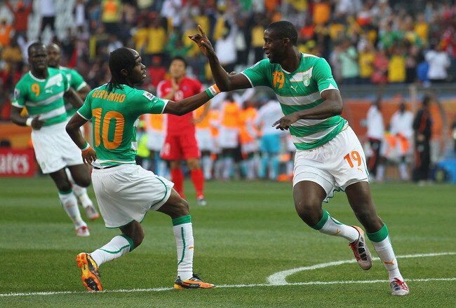 NELSPRUIT, SOUTH AFRICA - JUNE 25:  Yaya Toure of the Ivory Coast (C) celebrates scoring the opening goal with  team mate Gervinho during the 2010 FIFA World Cup South Africa Group G match between North Korea and Ivory Coast at the Mbombela Stadium on June 25, 2010 in Nelspruit, South Africa.  (Photo by Clive Rose/Getty Images)