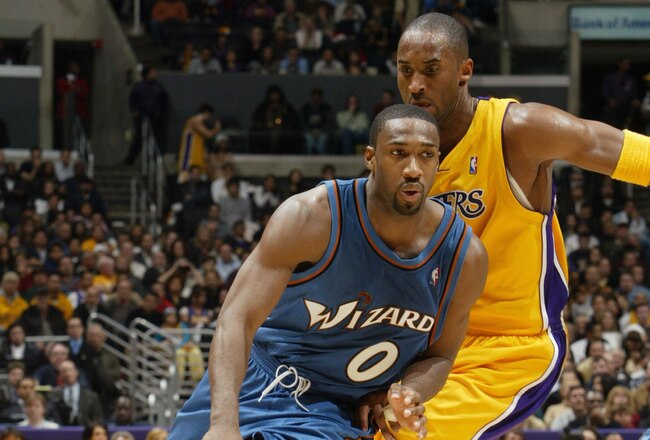 LOS ANGELES - DECEMBER 16:  Gilbert Arenas #0 of the Washington Wizards drives past Kobe Bryant #8 of the Los Angeles Lakers during a game at Staples Center on December 16, 2005 in Los Angeles, California.  The Lakers won 97-91.  NOTE TO USER:  User expressly acknowledges and agrees that, by downloading and/or using this Photograph, user is consenting to the terms and conditions of the Getty Images License Agreement. (Photo by Stephen Dunn/Getty Images)