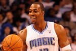 ORLANDO, FL - FEBRUARY 06:  Dwight Howard #12 of the Orlando Magic smiles during the game against the Los Angeles Clippers at Amway Center on February 6, 2012 in Orlando, Florida.   NOTE TO USER: User expressly acknowledges and agrees that, by downloading and or using this Photograph, user is consenting to the terms and conditions of the Getty Images License Agreement.  (Photo by Sam Greenwood/Getty Images)