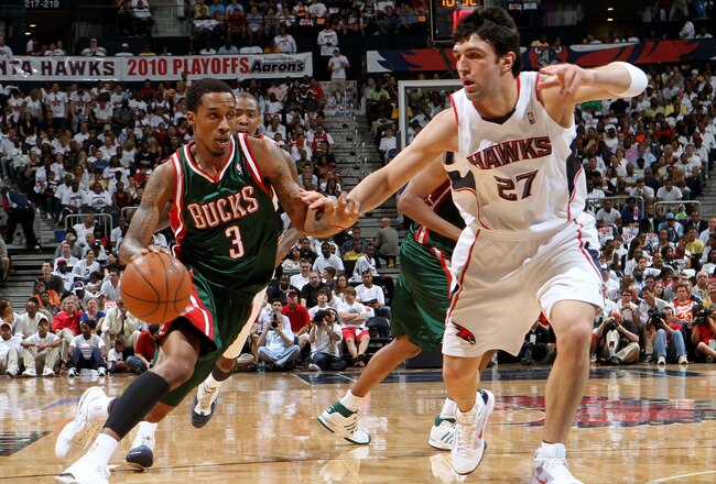 ATLANTA - MAY 2:  Guard Brandon Jennings #3 of the Milwaukee Bucks dribbles past center Zaza Pachulia #27 of the Atlanta Hawks during Game Seven of the Eastern Conference Quarterfinals between the Milwaukee Bucks and the Atlanta Hawks during the 2010 NBA Playoffs at Philips Arena on May 2, 2010 in Atlanta, Georgia. The Hawks beat the Bucks 95-74.  NOTE TO USER: User expressly acknowledges and agrees that, by downloading and/or using this photograph, user is consenting to the terms and conditions of the Getty Images License Agreement.  (Photo by Mike Zarrilli/Getty Images)