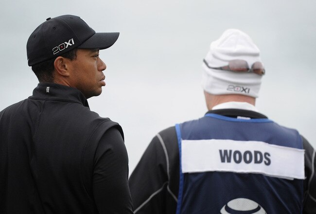 PEBBLE BEACH, CA - FEBRUARY 11: Tiger Woods (L) waits alongside caddie Joe LaCava (R) on the tenth green during the third round of the AT&T Pebble Beach National Pro-Am at Pebble Beach Golf Links on February 11, 2012 in Pebble Beach, California.  (Photo by Harry How/Getty Images)