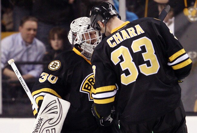 BOSTON, MA - JANUARY 31:  Tim Thomas #30 of the Boston Bruins celebrates the win with teammate Zdeno Chara #33 after the game against the Ottawa Senators on January 31, 2012 at TD Garden in Boston, Massachusetts. The Boston Bruins defeated the Ottawa Senators 4-3.  (Photo by Elsa/Getty Images)