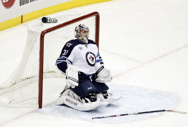PITTSBURGH, PA - FEBRUARY 11:  Ondrej Pavelec #31 of the Winnipeg Jets reacts after a goal by Evgeni Malkin #71 (not pictured) of the Pittsburgh Penguins during the game at Consol Energy Center on February 11, 2012 in Pittsburgh, Pennsylvania.  (Photo by Justin K. Aller/Getty Images)
