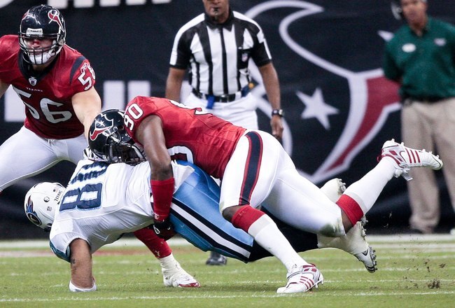 HOUSTON - NOVEMBER 23:  Tight-end Bo Scaife #80 of the Tennessee Titans is tackled by defensive end  Mario Williams #90 of the Houston Texans as linebacker Brian Cushing #56 positions to make a tackle at Reliant Stadium on November 23, 2009 in Houston, Texas.  (Photo by Bob Levey/Getty Images)