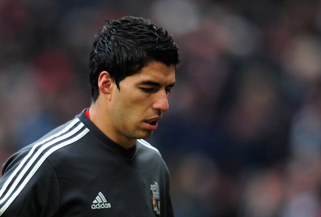 MANCHESTER, ENGLAND - FEBRUARY 11:  Luis Suarez of Liverpool walks off after the warm up prior to the Barclays Premier League match between Manchester United and Liverpool at Old Trafford on February 11, 2012 in Manchester, England.  (Photo by Shaun Botterill/Getty Images)